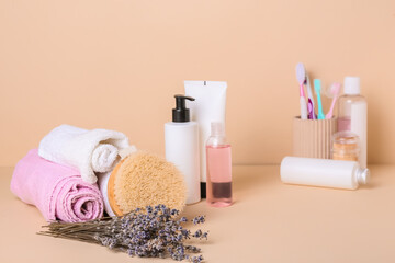 Composition with bath supplies and lavender flowers on color background