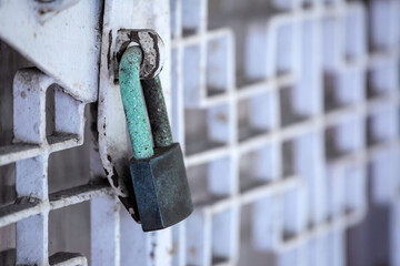 Metal gate is locked with rusty key for a long time