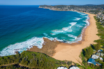 Blue ocean with large waves crashing on to North Avoca Shoreline in  New South Wales Australia