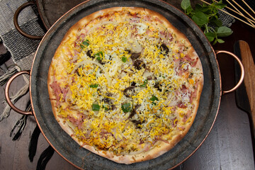 Brazilian Portuguese-style pizza with ham, egg, pepper, onion, mozzarella