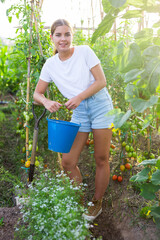 Portrait of woman farmer with bucket and shovel on the field. High quality photo