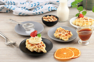 Fresh Baked Delicious Homemade Croissant Waffle with Strawberry and Milk for breakfast. Served on White Plate, Cream Clean Background for Advertising.