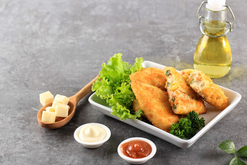 Vegetable Risoles with Triangle Shape. Thin Crepes Stuffed with Rogusa Corn, Carrot, and Green Bean, Served on White Plate with Cheese, Mayonaise, and Chilli Sauce. Copy Space on Grey Background