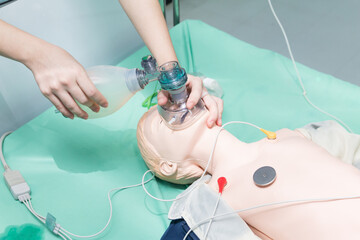 students are learning how to rescue the patients in emergency. CPR training with CPR doll and Ambu...