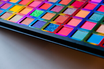 Flat lay of Broken bright multicolor eyeshadow as samples and swatches of cosmetic beauty product isolated on white background.