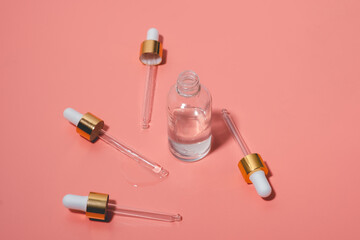 Dropper glass bottles with pipette. Transparent hyaluronic natural beauty product and eco serum skin care concept. Top horizontal view copyspace.