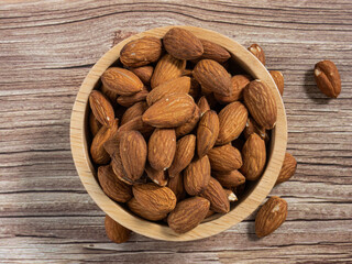 almond in wood bowl on wood table for food and health  concept