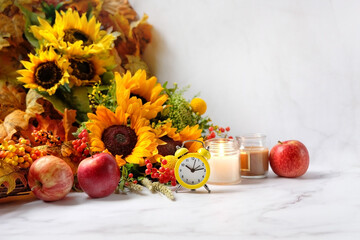 Autumn flowers bouquet, apples, alarm clock, candles. autumn seasonal composition. fall time, mabon sabbat, thanksgiving concept. - obrazy, fototapety, plakaty