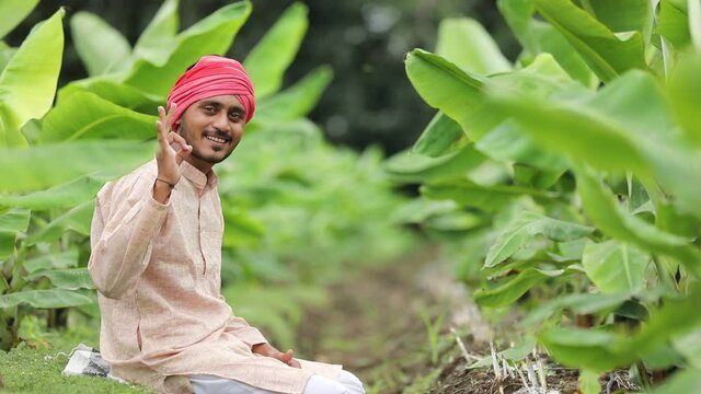 Young Indian farmer at green banana field
