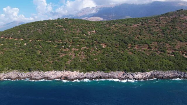 Beautiful coastline of Mediterranean in Albania, with hills and cliffs washed by blue turquoise sea water