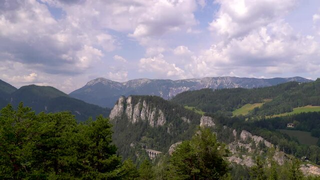 Wide open panorama timelapse with mountains, green hills and blue sky