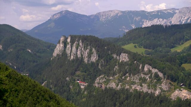 Freighter Train passing at Railway through stunning mountain landscape in Austria