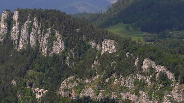 Slow pan across Semmering Railway Landscape in mountain landscape with train