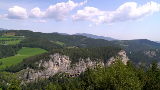 Panoramic Aerial view of rocky cliffs in incredible green European mountain landscape