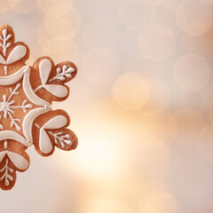 illustration of a snowflake in gold color with a blurred background