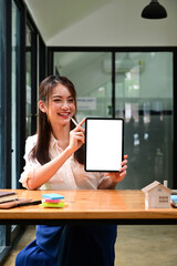 Portrait Asian woman showing digital tablet with empty screen.