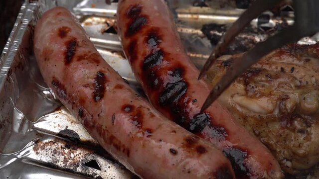 Slow motion, Pressing a Sausage on a Barbecue with a Fork