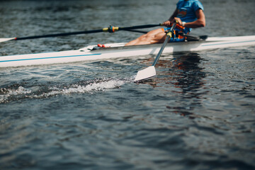 Sportsman single scull man rower rowing on boat. Oar paddle water splash movement - obrazy, fototapety, plakaty