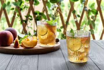 Summer mocktail or iced tea made from peach, lime, and mint