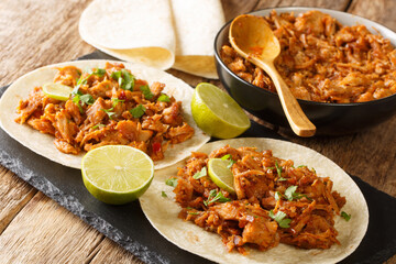 Chilorio Tacos tasty Mexican food closeup in the slate board on the table. Horizcontal
