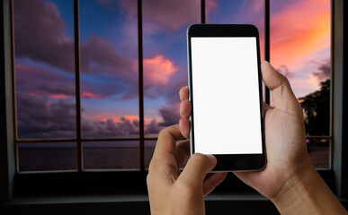 A man hand holding smart phone device in sky,river and mountain front view background