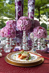 luxury wedding rom banquet sit down buffet party catering in pink purple rose color flower and black feather decoration with fusion halal menu at outdoor beautiful garden