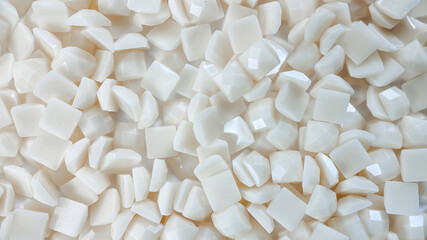 Close-up, white square diamonds for diamond embroidery. Hobbies and DIY, materials for creating diamond embroidery