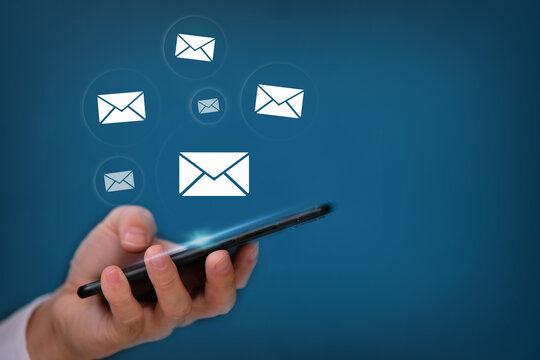 Hand using smartphone with sending email on blue background