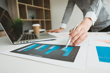 Businessman is deeply reviewing a financial report for a return on investment or investment risk...