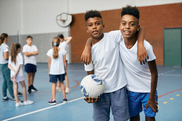 Happy African American boys have physical education class at school gym.