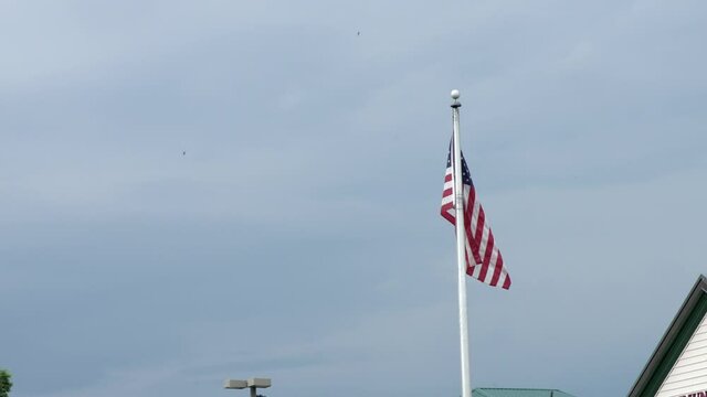 American Flag On Flagpole - National Flag Of The United States of America. - wide shot