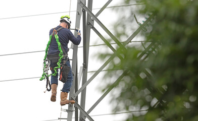 Electrician is working on a pole