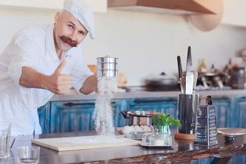 french chef in the kitchen preparing food, cooking, haute cuisine, man with mustache