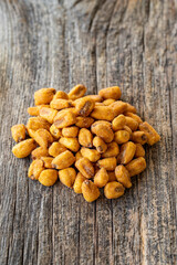Roasted corn snack. Corn nuts with sauce on wood background. bulk corn nut grains