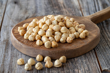 Roasted hazelnut. Hazelnuts on wood background. Bulk Hazelnut kernels