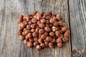 Organic Hazelnut. Hazelnuts on wood background. Bulk Hazelnut kernels