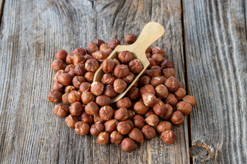 Hazelnut snack. hazelnut on wooden spoon. Bulk Hazelnut nut grains.