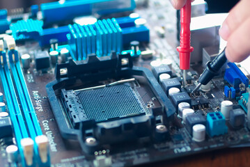 Hands fixing motherboard of pc or laptop notebook close up in service