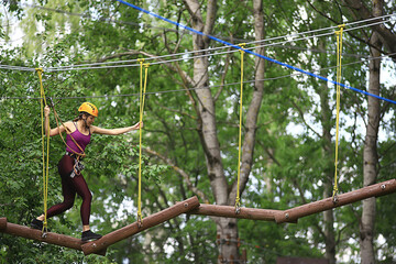 extreme vacation, girl in a yellow helmet rope park active holidays in the forest