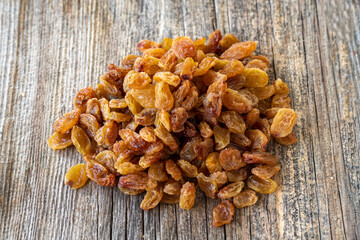 Raisins. Dry raisins on wood floor. Bulk Raisins grains