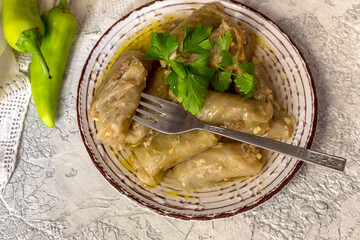 Cabbage rolls in a plate on a wooden table