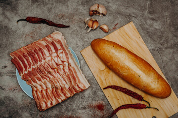 fresh sliced bacon on a gray stone background