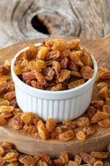 Dry raisins. Dry raisins nuts on wood floor. Bulk raisins grains. Raisins on a ceramic plate