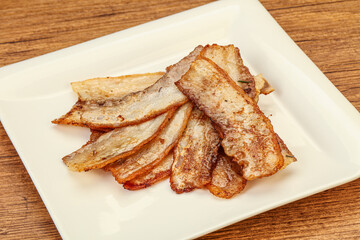 Roasted juicy bacon in the plate