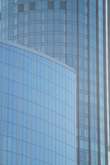Obraz premium Photo of the textures of the business center of a big city. Parts of the glass facades of skyscrapers. Linear radial structures.