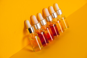 Dropper glass bottles with pipette. Transparent hyaluronic natural beauty mineral product and eco serum skin care concept. Top horizontal view copyspace. Summer juicy colors.