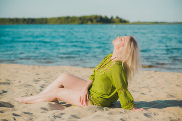 Naklejka premium Beautiful plus size woman in khaki linen dress rest at nature, concept of woman's fashion. Lady xl size having fun on a beach