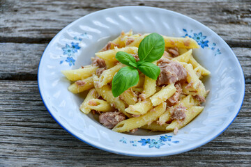  Italian home made   penne pasta  with  tuna  fish, parmesan cheese and black pepper .