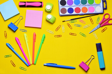 Naklejka premium Assorted school accessories on yellow background, zenith view. Copy space.