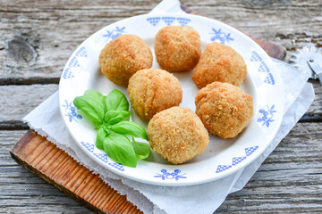 Italian arancini Cacio e pepe. Home made rice balls with mozzarella cheese ,parsley ,lemon and parmesan cheese.
